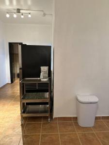 a room with a toilet and a trash can at Newly remodeled 3 BR Center Mayagüez, First Floor Unit1 in Mayaguez
