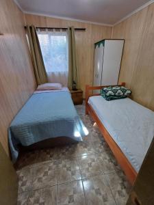 Cama o camas de una habitación en CABAÑAS MARISOL