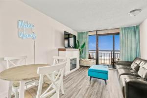 a living room with a table and a couch at 441 Landmark Resort in Myrtle Beach