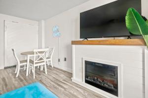 a living room with a fireplace with a flat screen tv at 441 Landmark Resort in Myrtle Beach