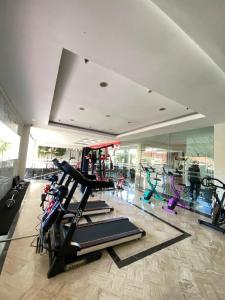 a gym with a bunch of treadmills and machines at Luxury Malioboro Hotel in Yogyakarta