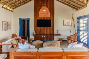 a living room with a couch and a tv at Casa de Praia Perfeita in Fortim