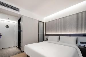 Postel nebo postele na pokoji v ubytování Atour Light Hotel Zhoushan Dinghai South Renmin Road