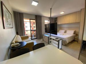 a hotel room with a bed and a tv at Flat central em brasilia in Brasilia