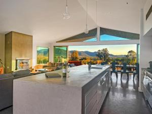 a large living room with a kitchen with a view at Pindara in Broke