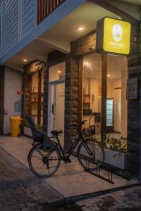 a bike parked in front of a building at Alba Inn Sanur by SooBali in Sanur