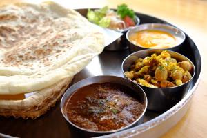 a tray with various dishes of food on a table at Azumino World Curry House Spice Road in Matsukawa