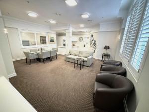 a living room with a couch and chairs and a table at Royal Albert Hotel in Brisbane