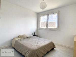 a white bedroom with a bed and a window at Maison Camaret-sur-Mer, 7 pièces, 8 personnes - FR-1-370-82 in Camaret-sur-Mer