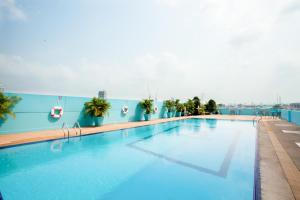 a large swimming pool on top of a building at Riverside Bangkok Hotel in Bangkok