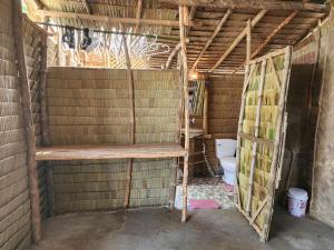 a bathroom with a toilet in a building at BICE Camp Bucana Beach in El Nido