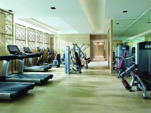 a gym with rows of treadmills and machines at Langham Place Guangzhou - Walking distance to Canton Fair in Guangzhou