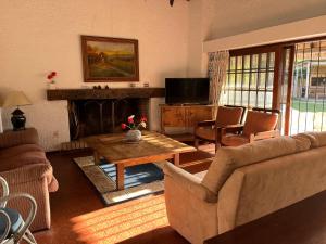 a living room with a couch and a table at Villa Carolina in Punta del Este