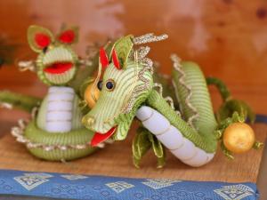 two toy figurines of a green dragon on a table at コテージ野の香 in Omachi
