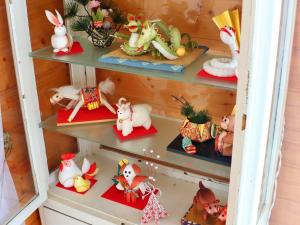 a shelf full of christmas toys in a cabinet at コテージ野の香 in Omachi +196 photos
