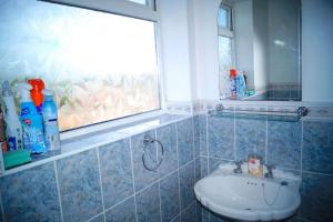 a bathroom with a sink and a window at 3 Bed House with Exceptional view in Batley