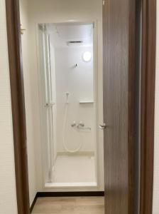 a bathroom with a shower with a sink and a shower at 広島ゲストハウス Nice Day in Hiroshima