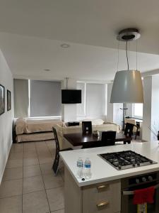 a kitchen and living room with a stove top at Carso Alameda Premium Apartments in Mexico City