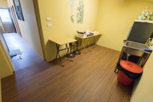 an office with a room with a table and a television at 31 Backpack Guest House in Ren'ai