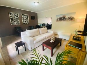 a living room with a white couch and a table at Little Eden in St Lucia