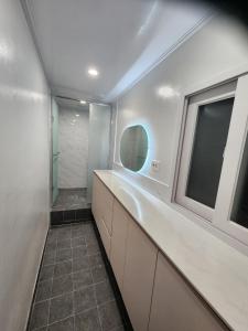 a bathroom with a sink and a mirror and a window at Stay 2002 in Seoul