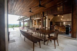 a dining room with a large wooden table and chairs at Villa Sorgas in Kuta Lombok
