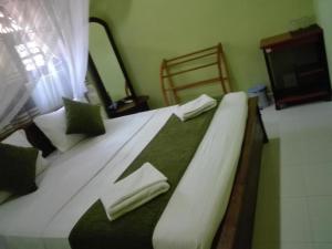 Cama o camas de una habitación en Sigiriya Peacock Homestay