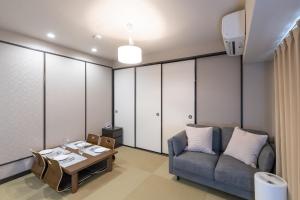 a living room with a couch and a table at 心斎橋-道頓堀の宿 ー南海難波徒歩10分以内 in Osaka