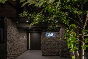 a sign on the side of a brick building at 心斎橋-道頓堀の宿 ー南海難波徒歩10分以内 in Osaka