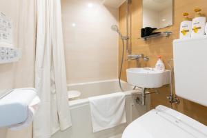 a bathroom with a tub and a toilet and a sink at 心斎橋-道頓堀の宿 ー南海難波徒歩10分以内 in Osaka