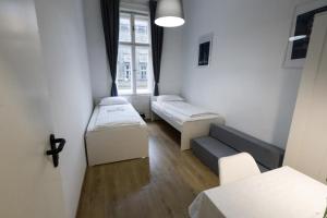 a room with two beds and a window at Pest-port apartment 4 rooms for 16 person in Budapest