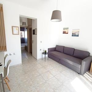 a living room with a couch and a table at R&T Apartments in Kallithea Halkidikis