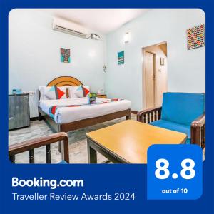 a hotel room with a bed and a table at FabExpress Santhi Inn, Promenade Beach in Puducherry