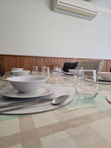 a long table with plates and glasses on it at The Golf Getaway in Myrtleford