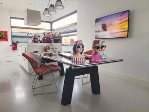 two dolls sitting on a glass table in a kitchen at Paradise Amsterdam bungalow of 80 m2 with private pool - All inclusive, breakfast, parking, use of bikes, tourist tax and much more in Zandvoort