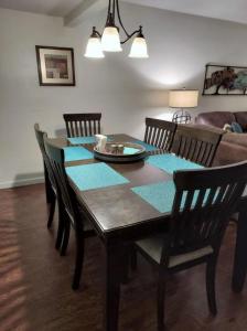 a dining room with a table with chairs and a couch at Lovely 2 Bedroom Condo with Views of the Mountains in Gatlinburg