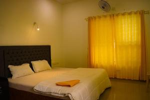 a bedroom with a bed with two towels on it at Nest Villa in Athirappilly