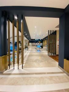 a hallway with tables and chairs in a building at Suites By Migrolino in Lucknow