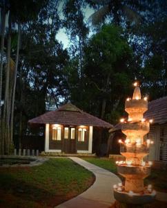 a fire hydrant with lights in front of a house at Shantitheeram Ayurveda Lakeside Heritage Resort in Alleppey