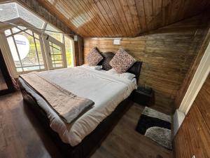1 dormitorio con 1 cama en una habitación de madera en Lidder view resort, en Pahalgām