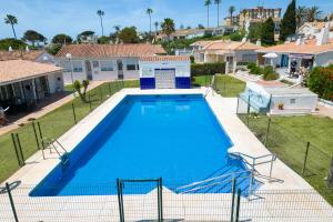 an overhead view of a swimming pool in a yard at Family villa with garden next to the beach in Mijas Costa