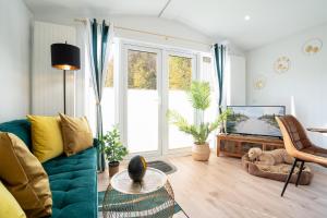 ein Wohnzimmer mit einem blauen Sofa und einem TV in der Unterkunft Ostseecamp Klabautermann in Scharbeutz