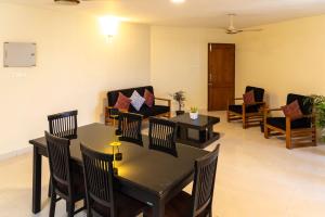 a dining room with tables and chairs in a room at BEST SERVICED APARTMENT IN COCHIN,MARINE DRIVE in Cochin