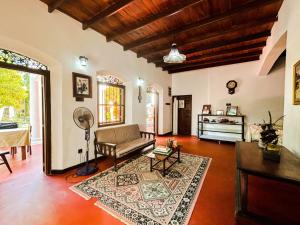 a living room with a couch and a table at Hotel La Felicita in Mirissa