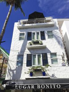 a white building with windows and plants on it at Lugar Bonito Hotel in Boracay