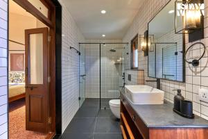 a bathroom with a sink and a toilet and a shower at StayVista's Villa Terra - Valley & Lake-View Villa with Spacious Lawn & Indoor Activities in Panchgani +22 photos
