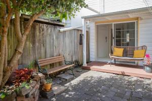 a porch with a bench and a chair on a house at 'Sweet Caroline' A Classic Newcastle Hideaway in Newcastle