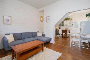 a living room with a blue couch and a table at 'Sweet Caroline' A Classic Newcastle Hideaway in Newcastle