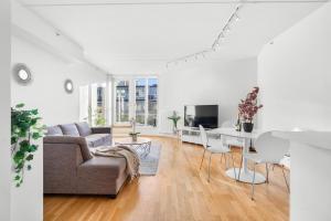 a living room with a couch and a table at Top floor with balcony - Super central - 5 pax in Oslo
