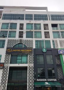 um grande edifício com uma placa de minivan do hotel em RJ STUDIO APARTMENT 2- Hotel Mutiara em Gua Musang
